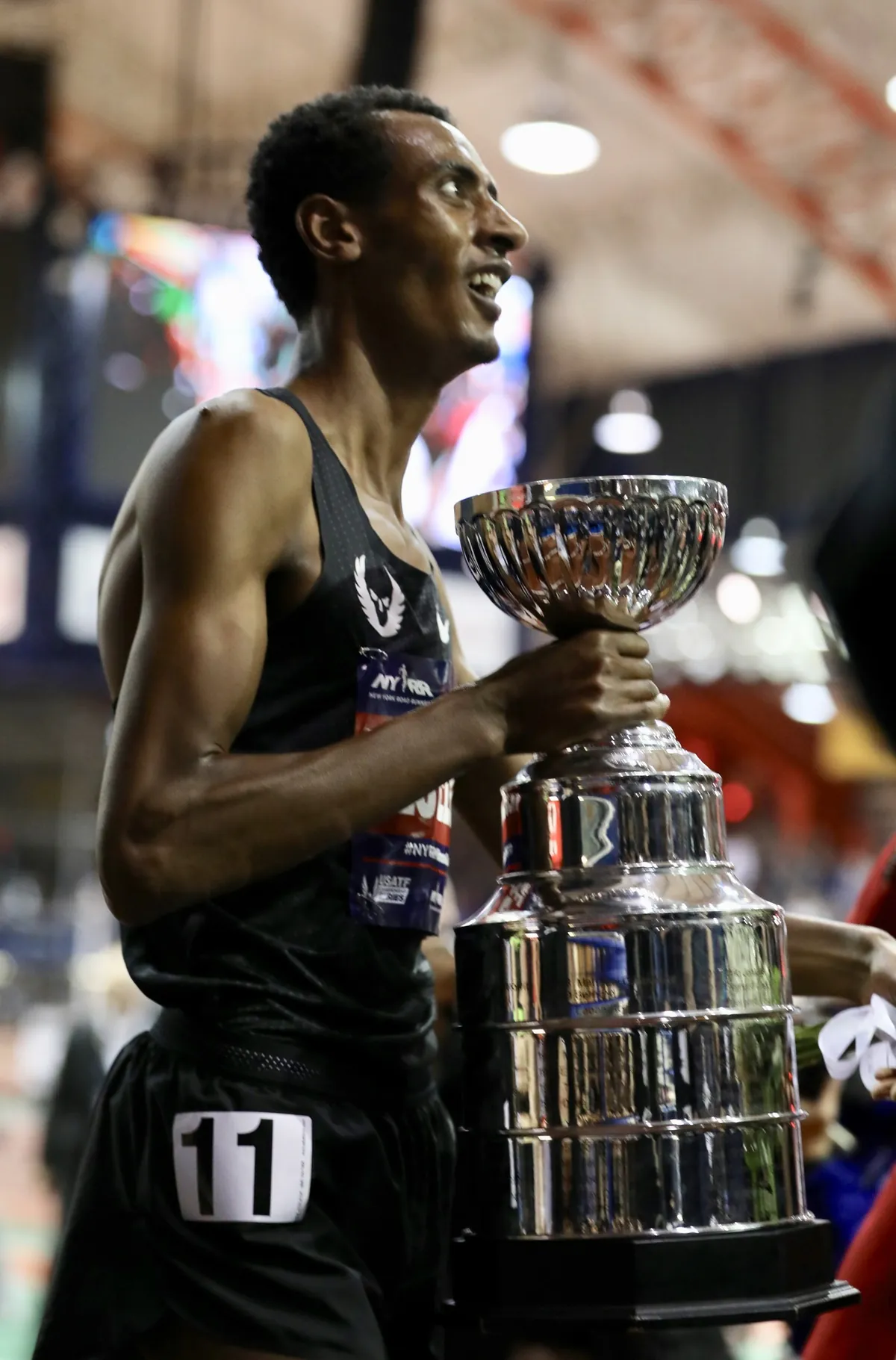 Yomif Kejelcha with the Wanamaker Mile trophy, Millrose Games 2019